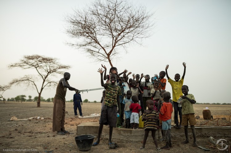 Different statges of drilling wells and installing hand pumps.